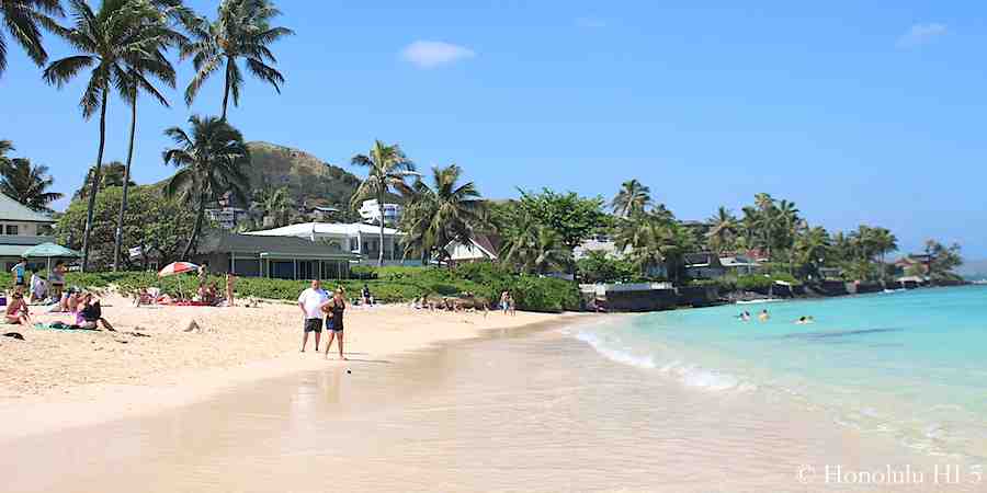 Lanikai beach front houses and people relaxing and enjoy the beach and ocean.