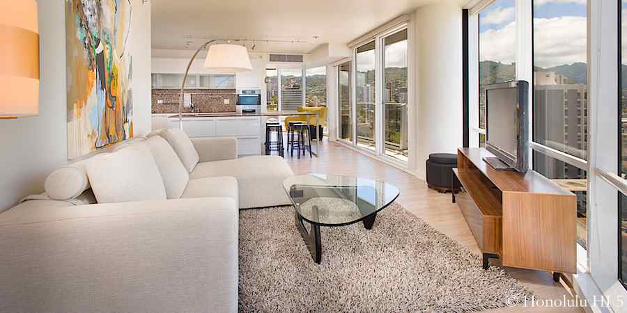 Living room in #1203 with kitchen and den in background